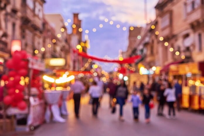 Defocused crowd of people shopping locally during the holiday period.
