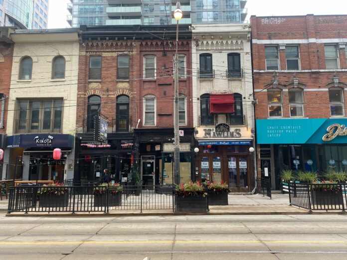 Row of small businesses on King Street West in Toronto. Photo: Dustin Fuhs