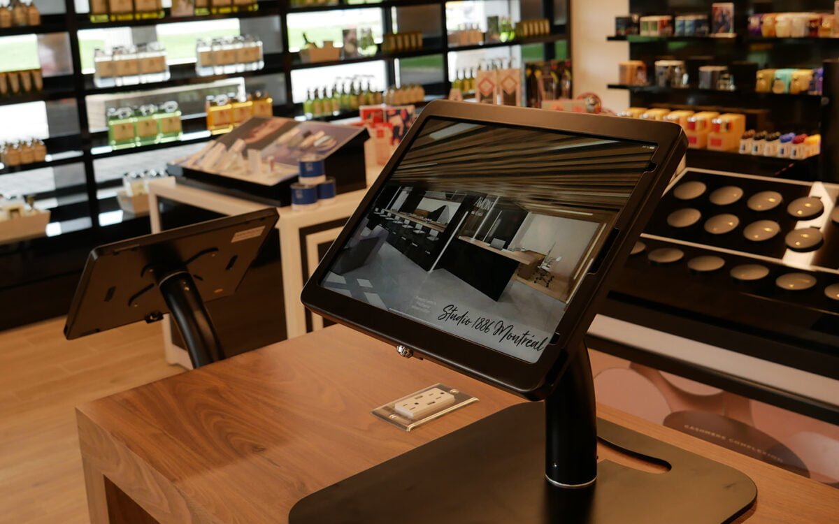 INTERIOR OF AVON STUDIO IN MONTREAL WITH INTERACTIVE IPADS. PHOTO: AVON