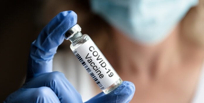 Doctor holds COVID-19 vaccine
