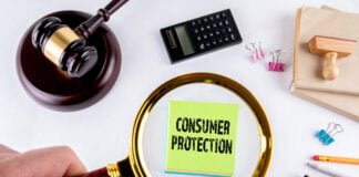Consumer protection, law and justice concept with man's hand holding magnifying glass.