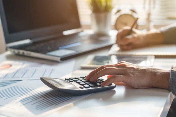 Businessman calculating business balance Businessman calculating business balance