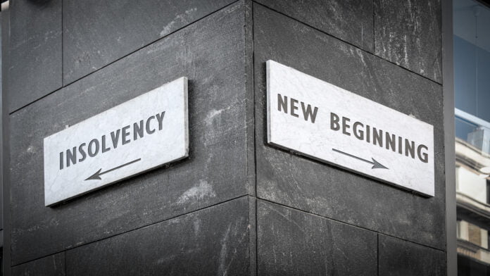 Street sign with directions to either NEW BEGINNING or INSOLVENCY Street sign with directions to either NEW BEGINNING or INSOLVENCY