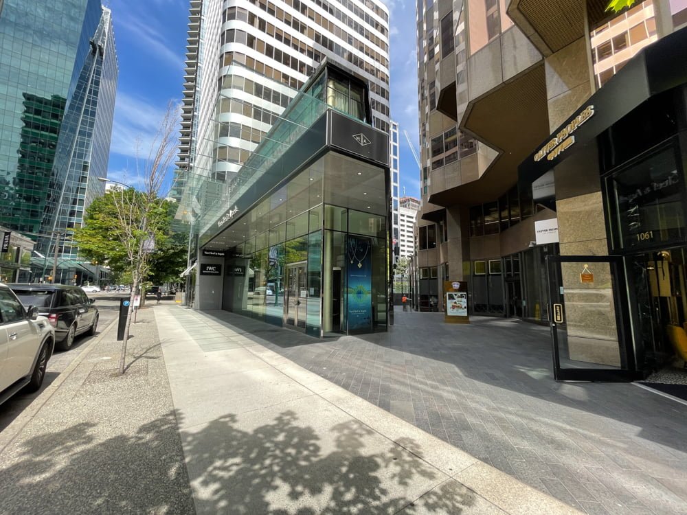 Sidewalk view on Alberni Street passing Oliver Peoples, the passthru to TWG Tea Salon & Boutique and Van Cleef & Arpels