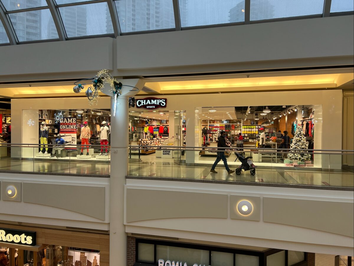 Champs Sports at Metropolis at Metrotown main entrance (December 2021). Photo: Lee Rivett.