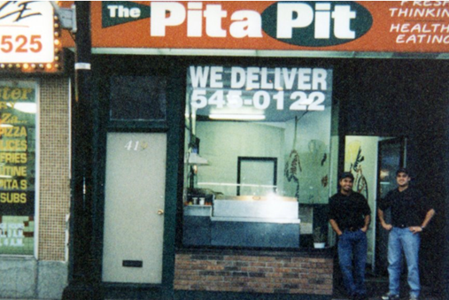Pita Pit founders John and Nelson in front of the first ever Pita Pit location in Kingston, Ontario, in 1995. Pita Pit celebrates its 30th anniversary this year.