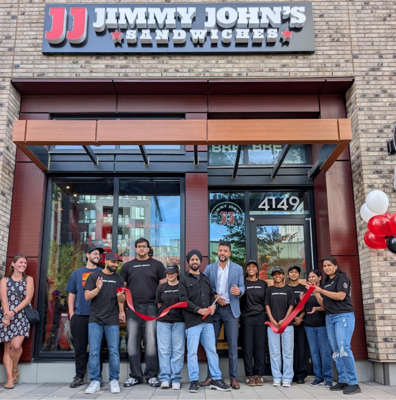 Jimmy John’s franchisee Mohit Saini (holding scissors) is joined by Novy Cheema, president and CEO of University of Calgary Properties Group (blue blazer), the restaurant’s first guests and team members to celebrate the grand opening of the first Calgary location on September 1, 2026. Photo: Foodtastic.